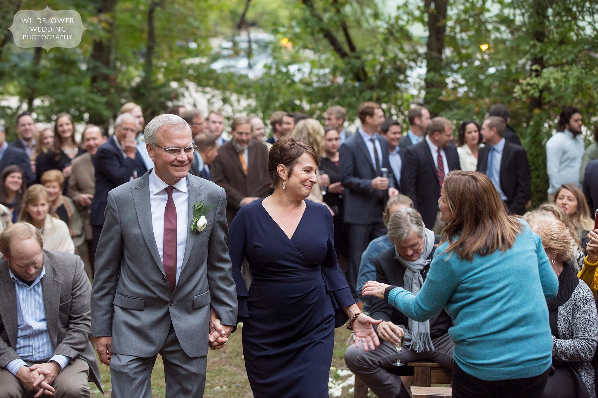 The parents of the groom walk down the aisle at Little Piney.