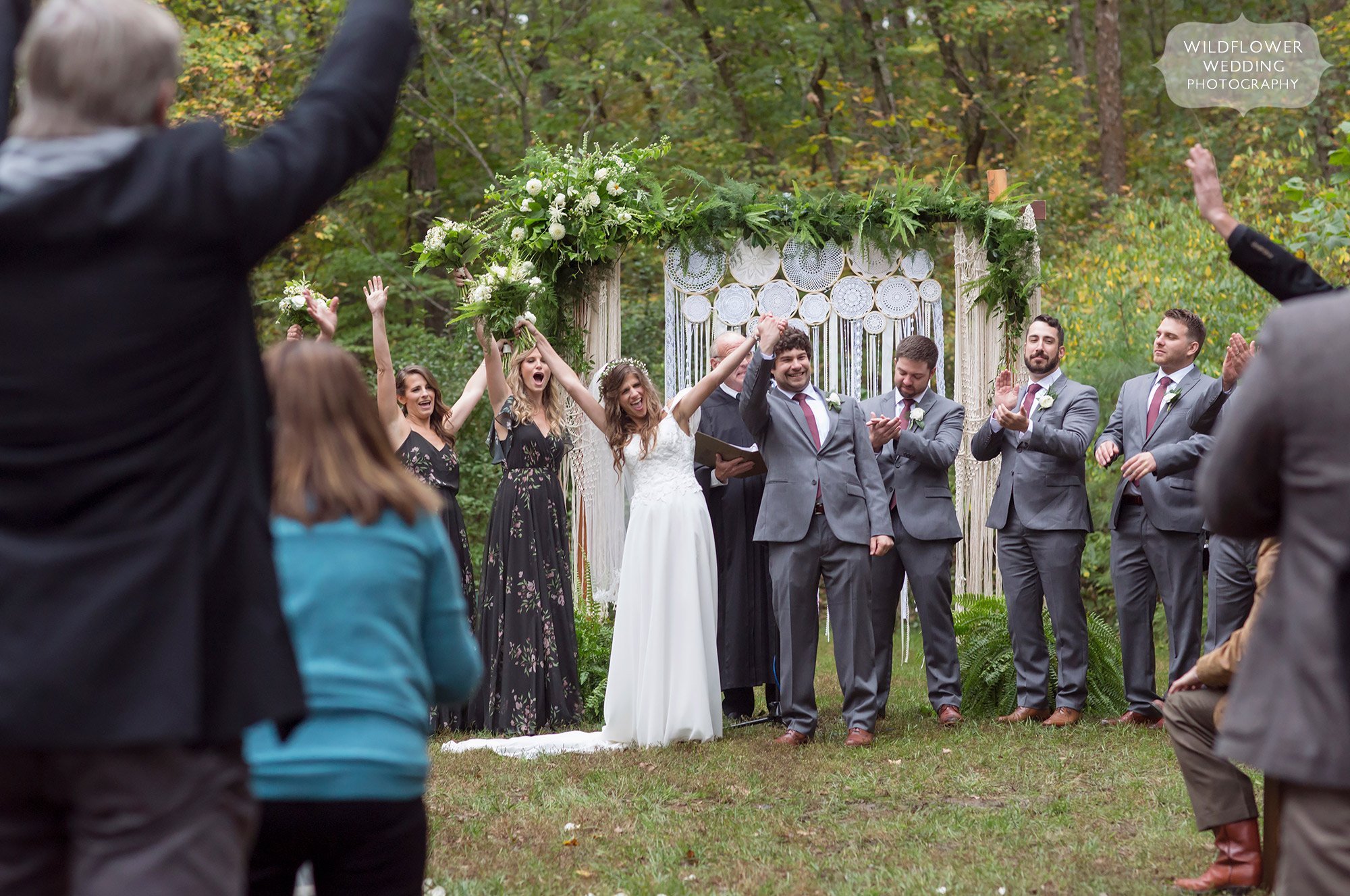 Joyful wedding photo of bride and groom celebrating at Little Piney Lodge.