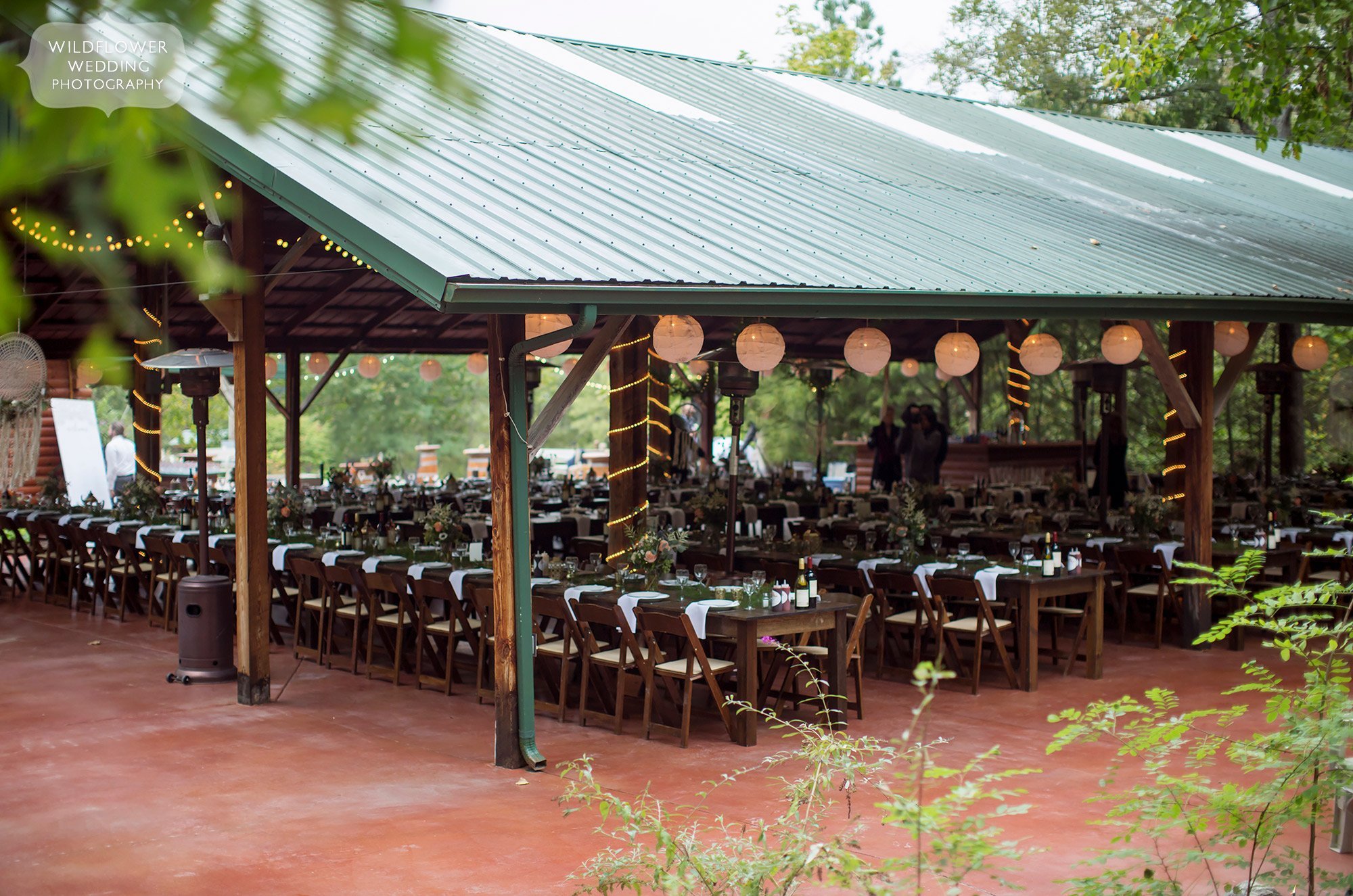 The Little Piney Lodge has a rustic covered pavilion for an outdoor wedding reception in Hermann, MO.