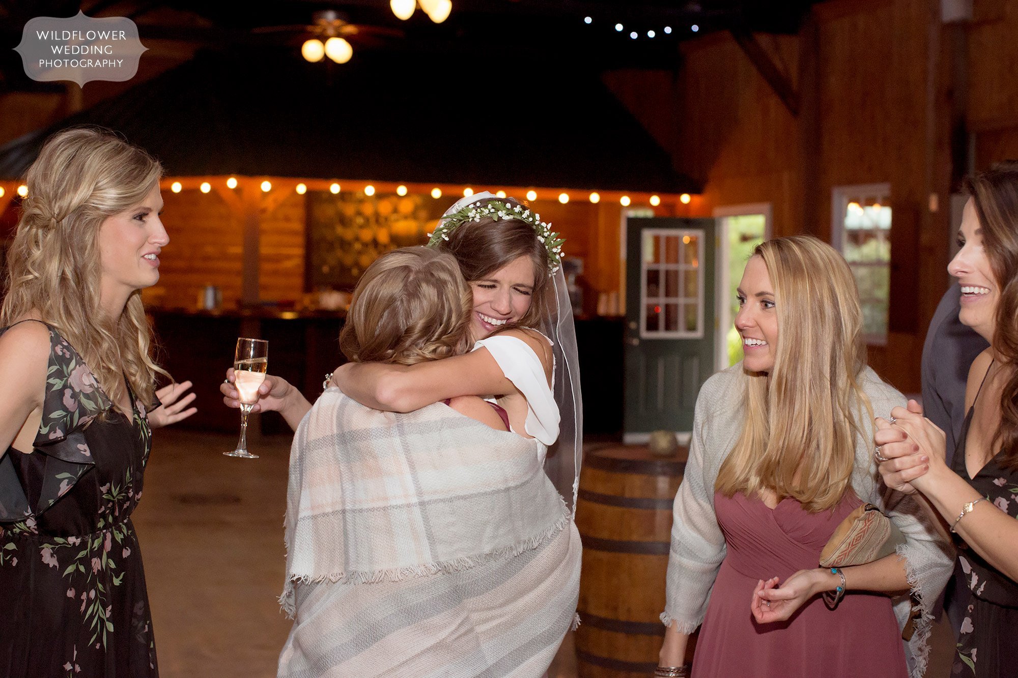 The bride hugs wedding guest at this outdoor Little Piney Lodge reception.