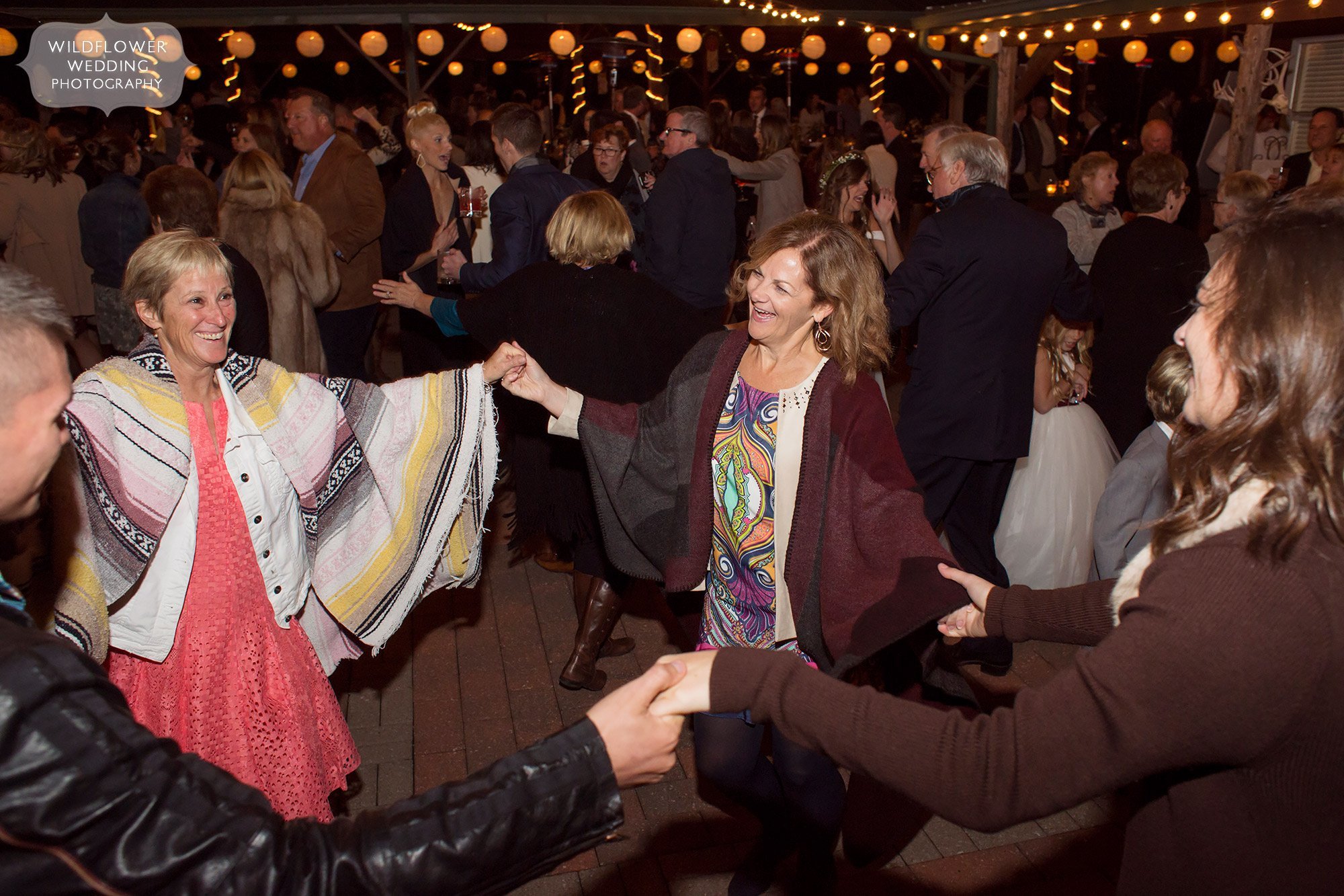 Guests dance outside at this Little Piney Lodge wedding in Mid-MO.