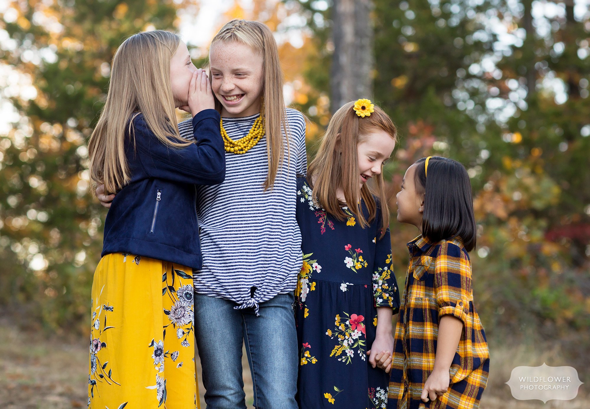 Girls tell secrets during this natural family photography session in Columbia.
