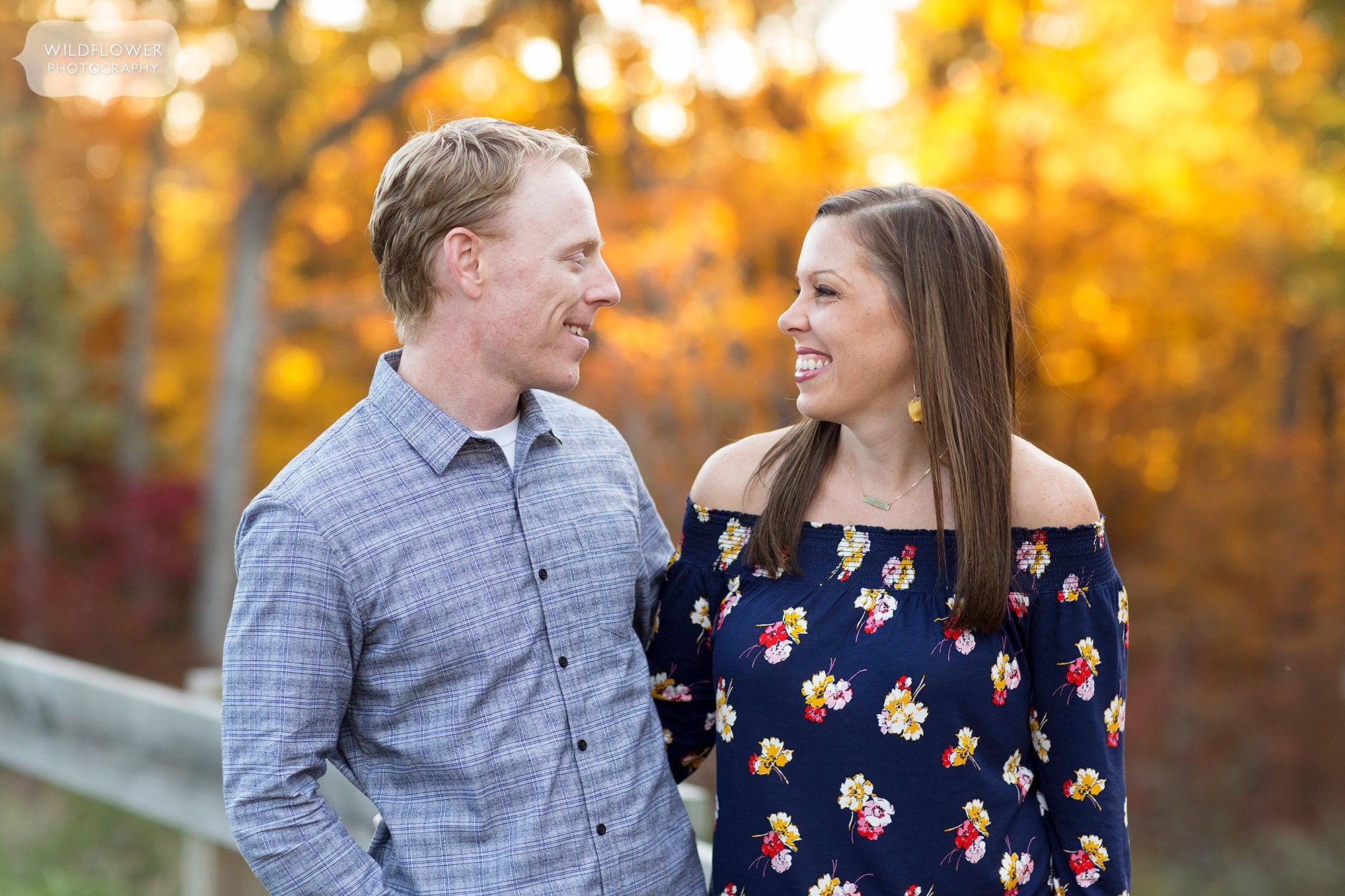 Parents smile at each other during this October family photography session in Columbia, MO.