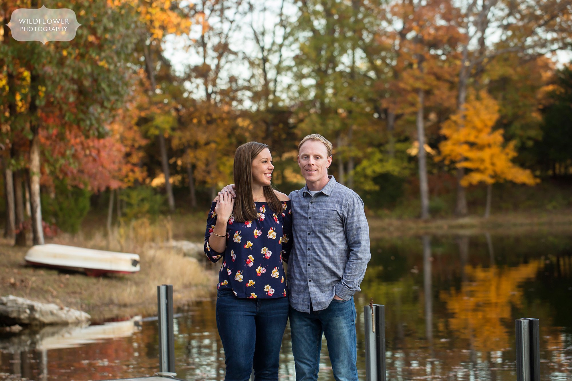 Parents pose by the lake for this October family portrait session.