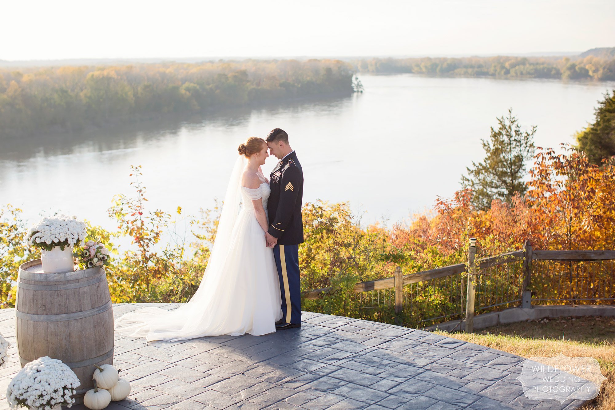 The bride and groom stand on the blufftop overlooking the river at this Les Bourgeois October wedding.