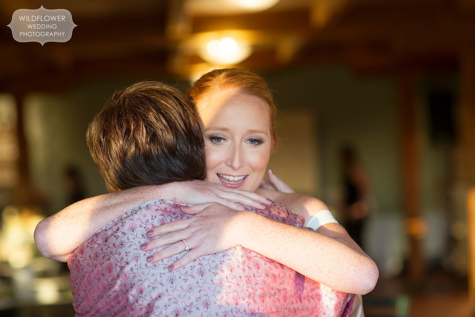The bride hugs her mom after Les Bourgeois October wedding ceremony.