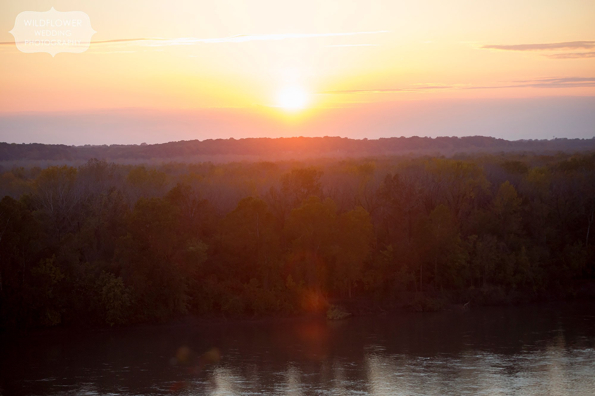 The sun sets over the Missouri River after a blufftop wedding ceremony at Les Bourgeois.