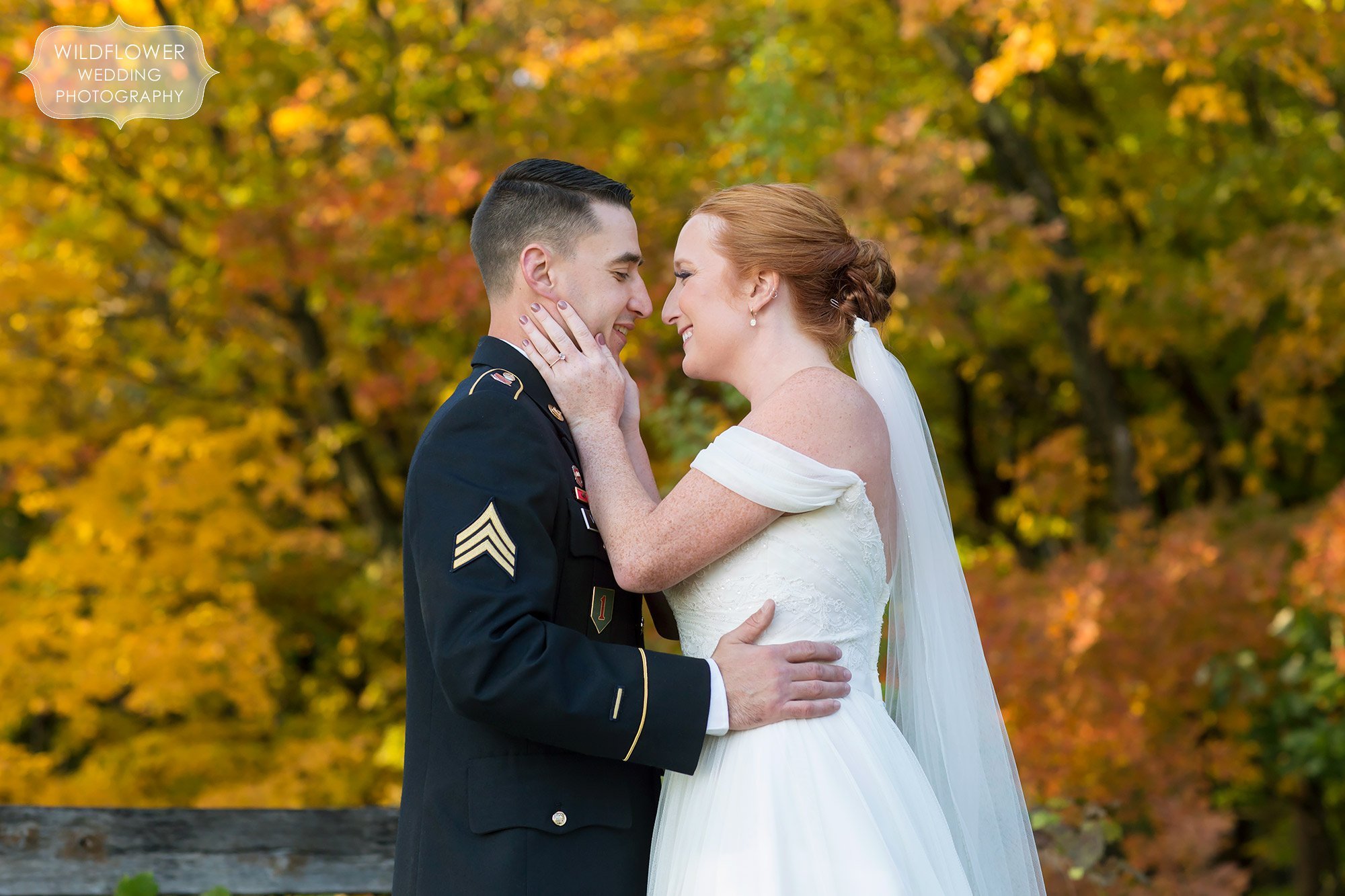 Bride and groom in the woods at their Les Bourgeois October wedding with fall colors.