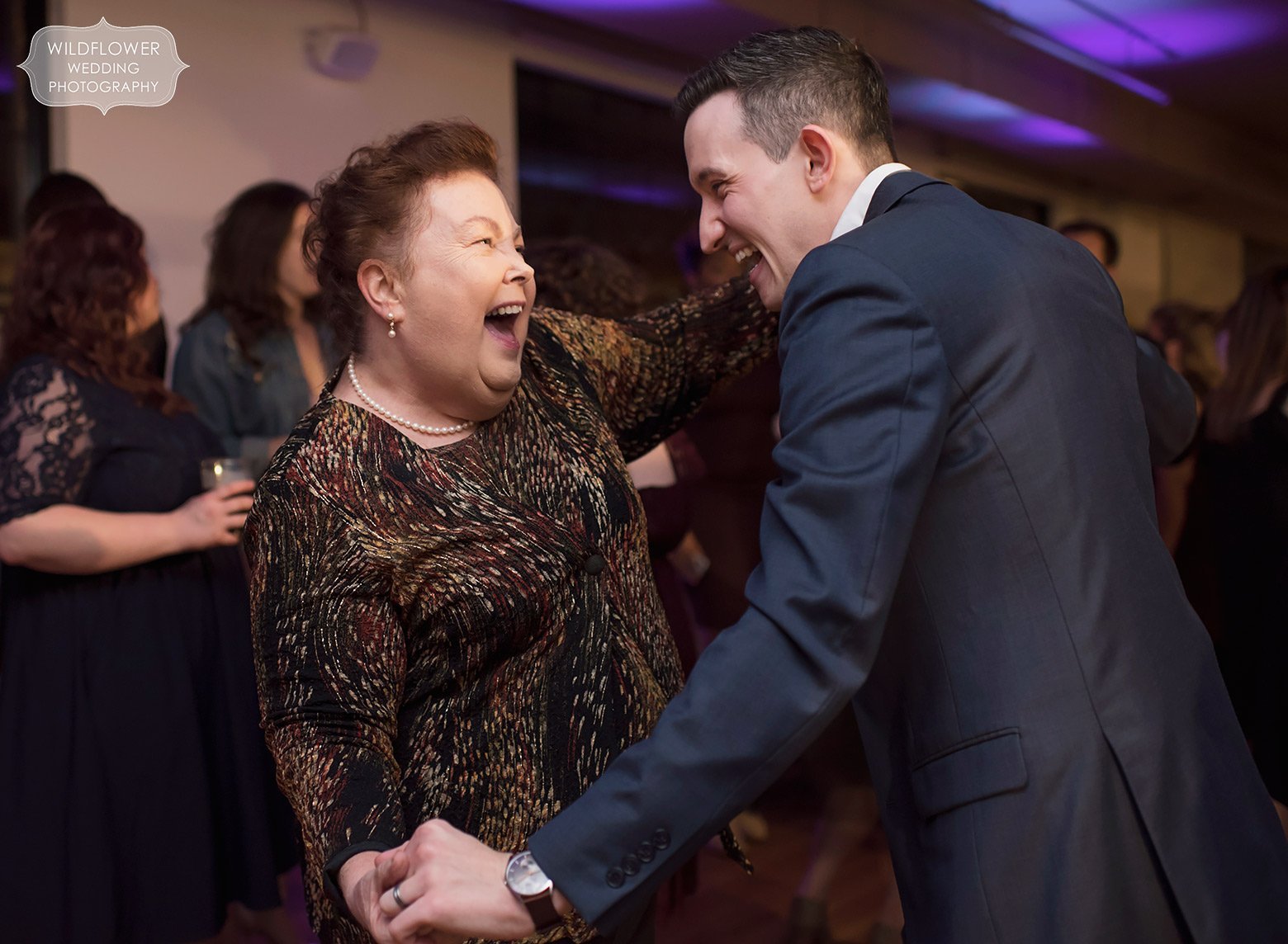 Fun dance photo of groom's mom and wedding guest at Sager Braudis.