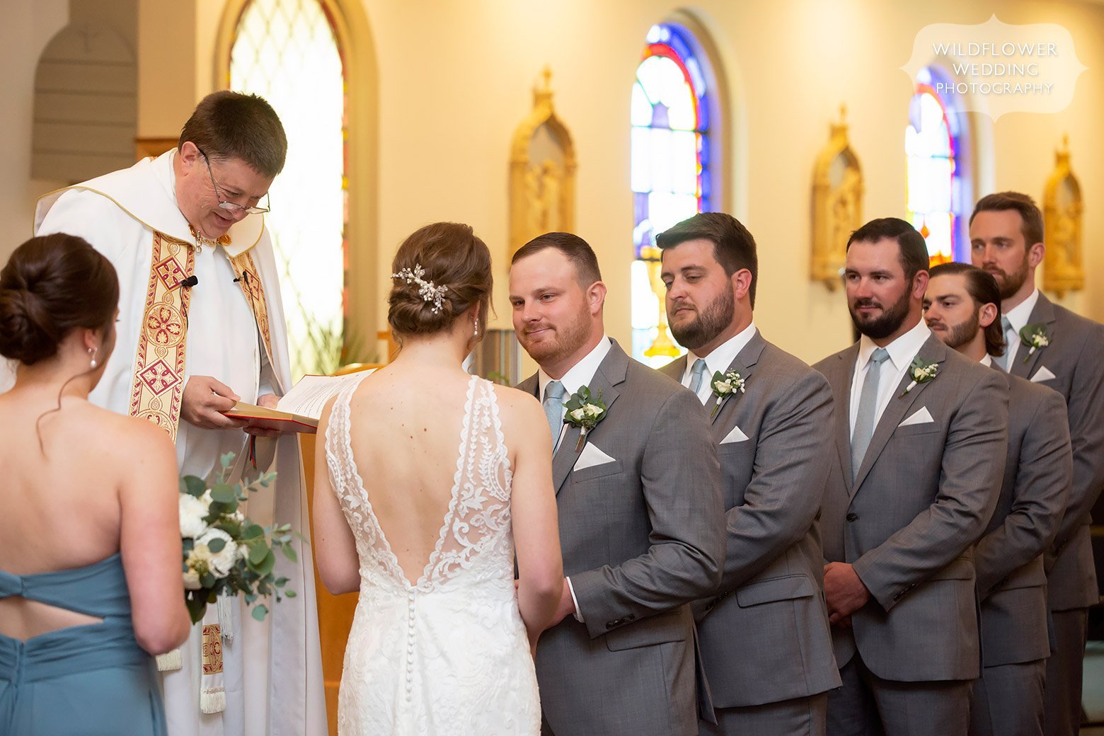 Groom reads vows to bride in church in Mid-MO.