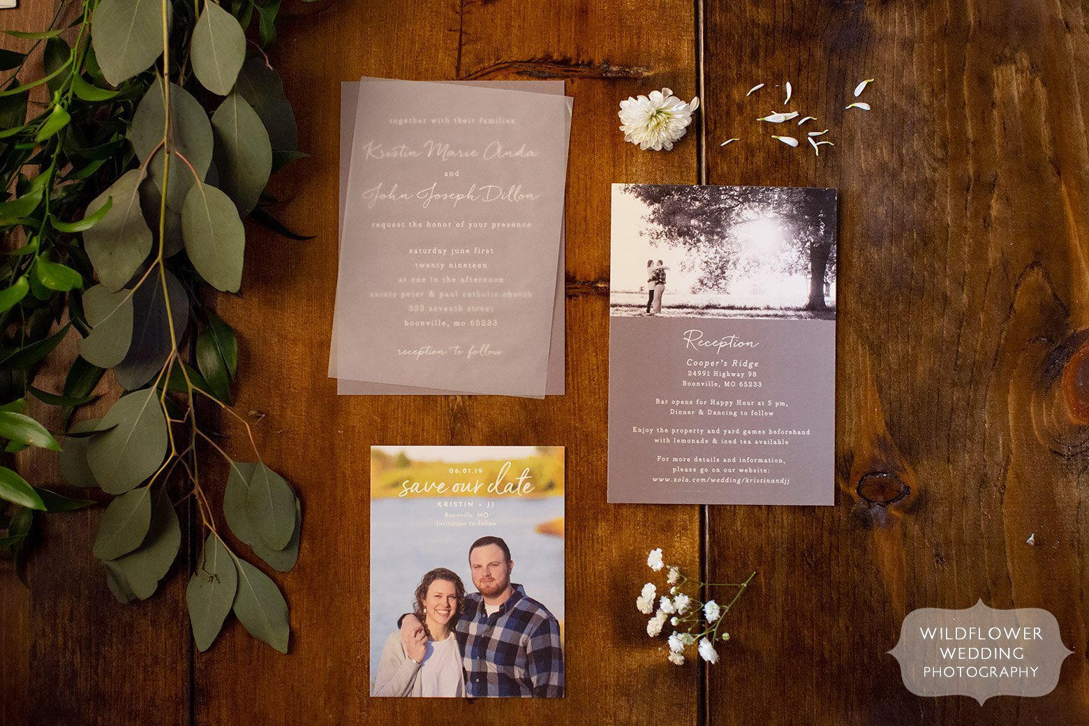 Cooper's Ridge wedding invitations on farm table.