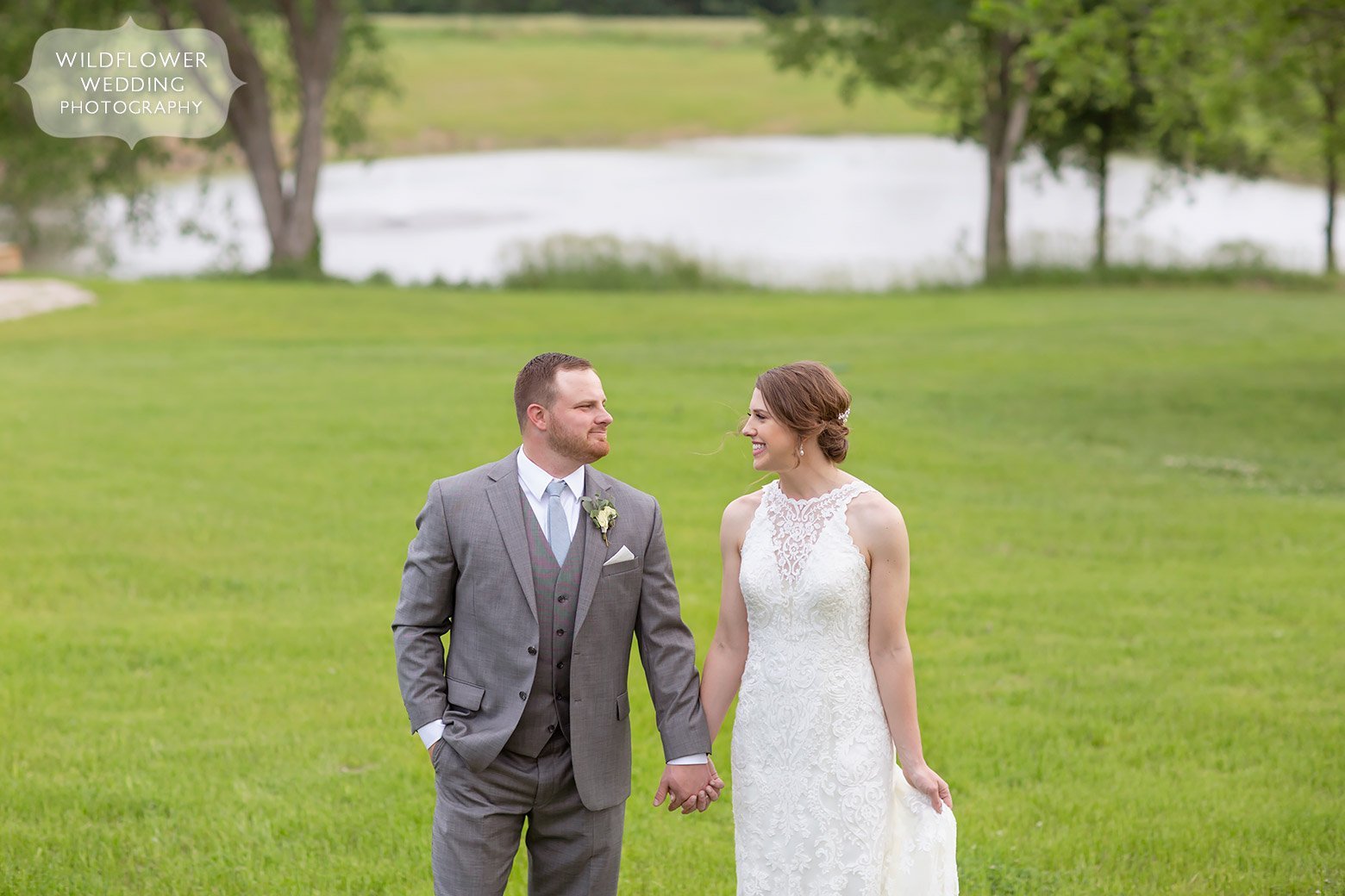 Bride and groom in front of pond at Cooper's Ridge outdoor wedding venue in mid-MO.
