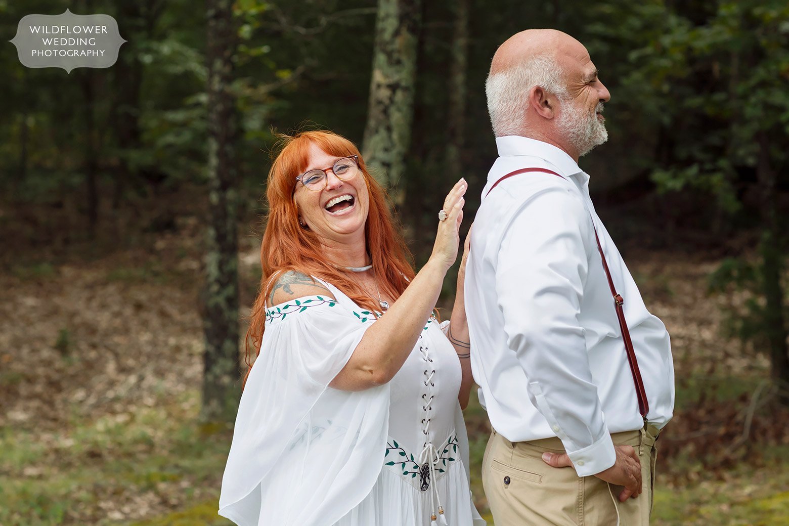 Bride taps groom on back before their first look in southern Missouri.