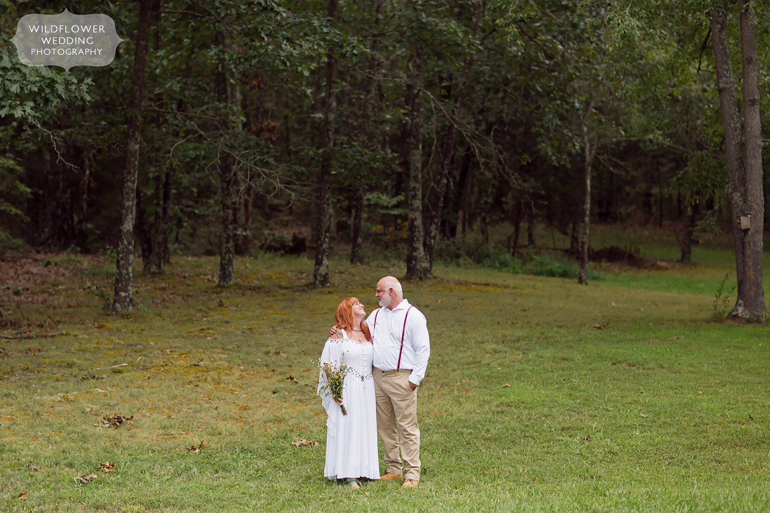 Bride and groom stand in a field in southern Missouri.