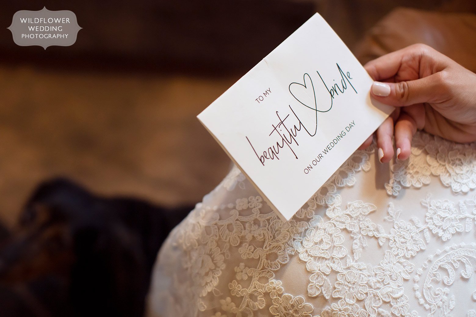Bride holds a card from the groom before her wedding in Jefferson City.