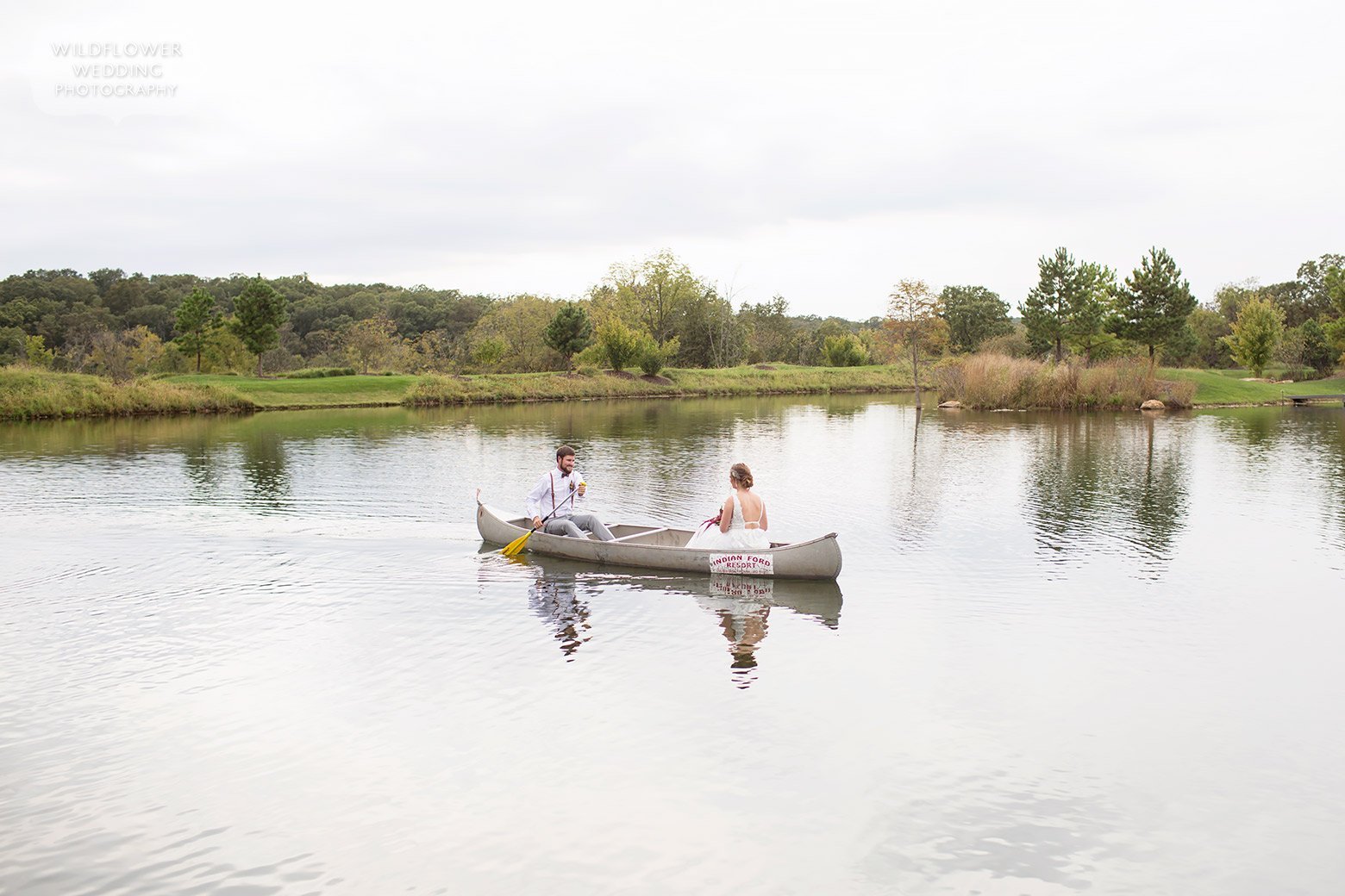 Bride and groom in a canoe in Hermann, MO wedding.