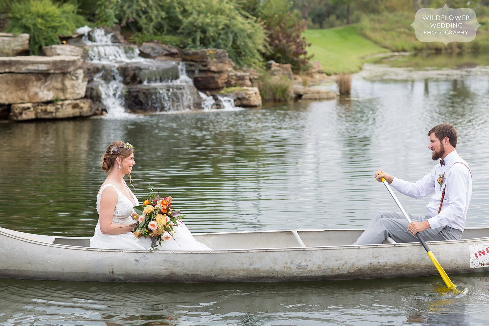 The bride and groom canoeing around a lake near Hermann, MO.