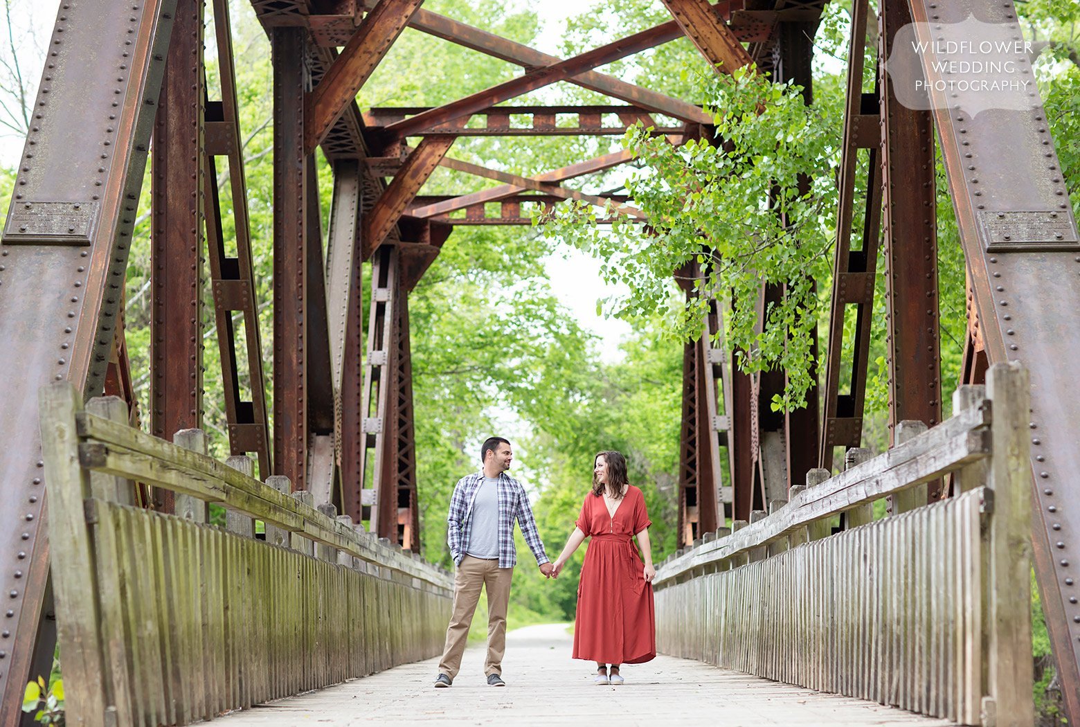 Couple stands on bridge during this Cooper's Landing portrait photography engagement session.