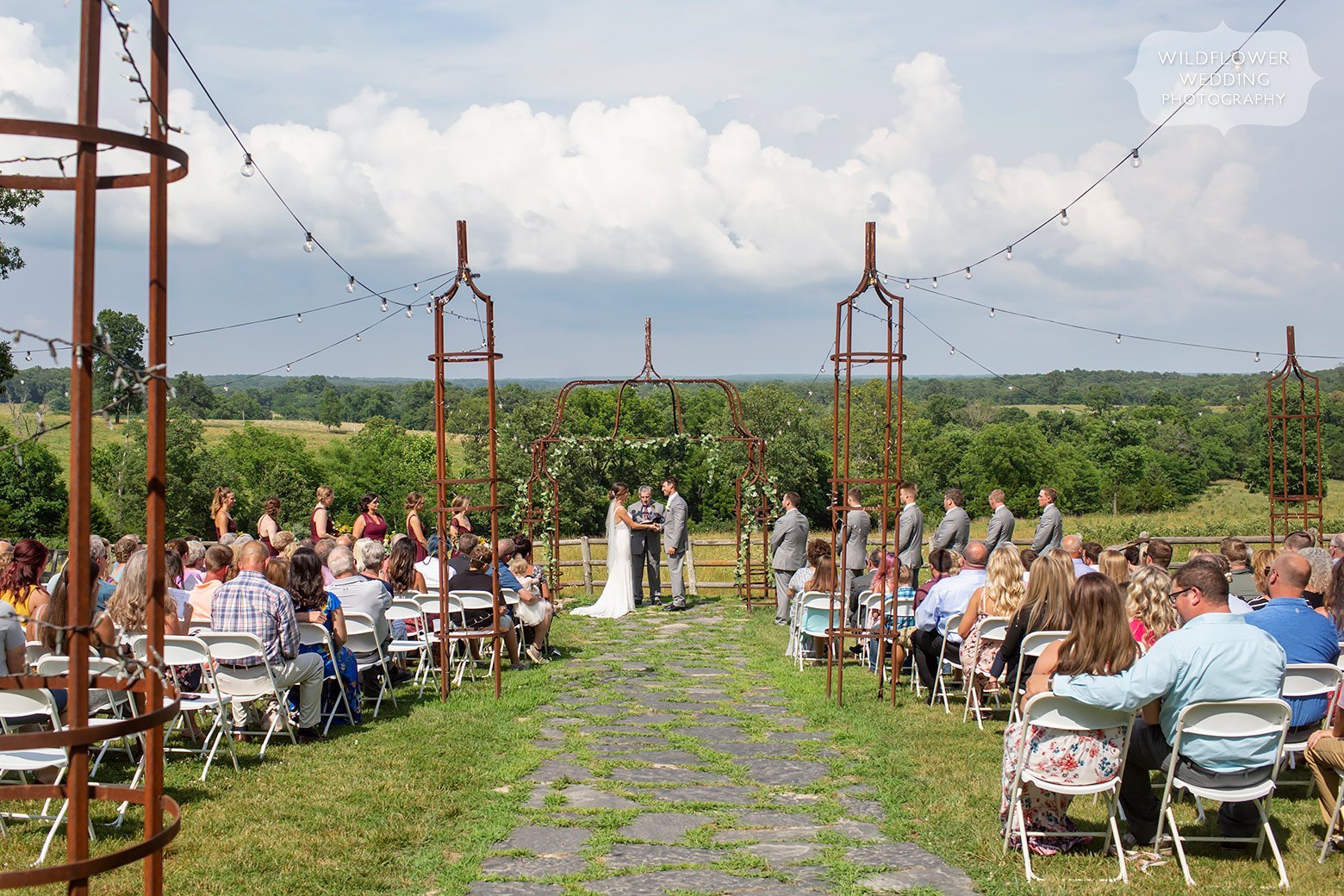 Bride and groom during outdoor spring wedding ceremony at Weathered Wisdom Barn.