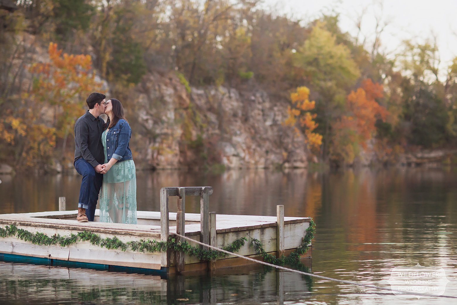 Couple stands on dock in the middle of quarry lake at Wildcliff Weddings venue.