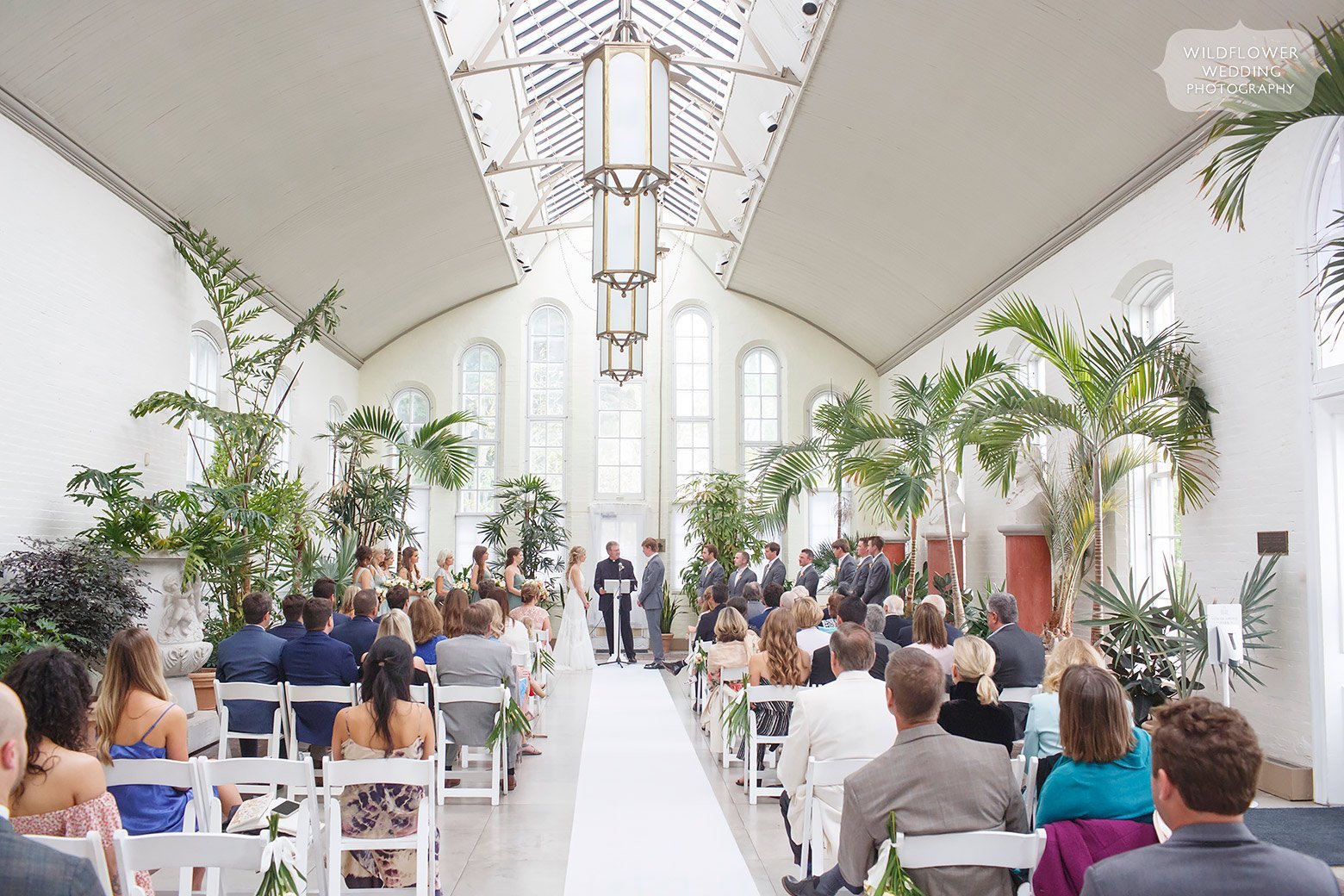 Indoor wedding ceremony at Piper Palm House in Tower Grove Park.