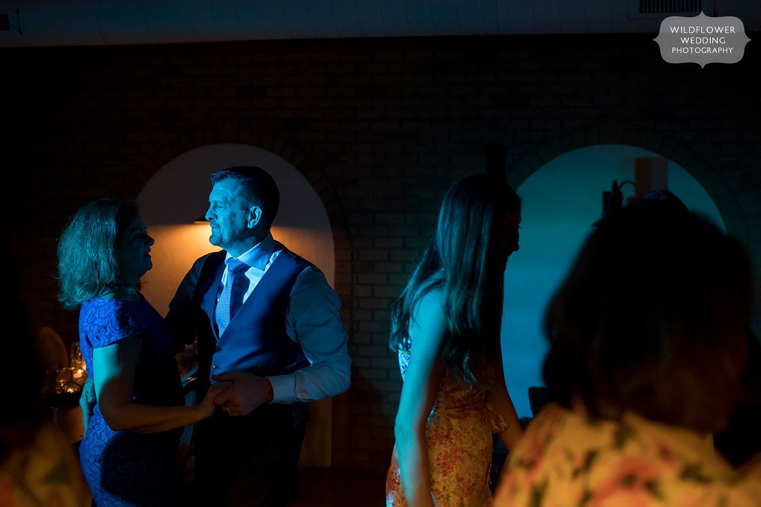 Blue light on the dance floor by creative St. Louis wedding photographer.